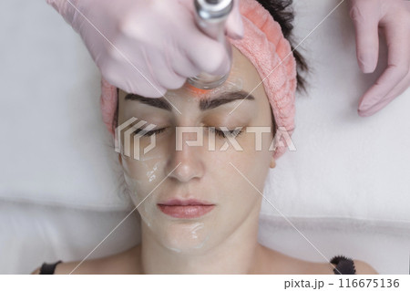 Cosmetologist making biolifting rf-lifting procedure. Rejuvenating skin, preventing aging, woman getting stimulating beauty facial treatment. hardware cosmetology in modern clinic. 4 k video 116675136