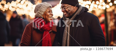 An African American middle-aged couple in love walks through the city at night on the eve of Christmas. An African American middle-aged couple in love walks through the city at night on the eve of Christmas. 116677694