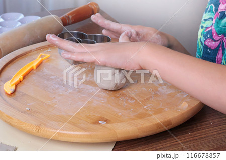 Young teenage girl molding ball of clay at home. Hobbies and tools. Creativity for children, education. Young teenage girl molding ball of clay at home. Hobbies and tools. Creativity for children, education. 116678857