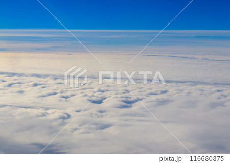 Beautiful white clouds in blue sky. View from airplane Beautiful white clouds in blue sky. View from airplane 116680875
