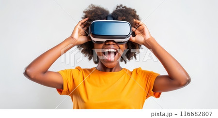 Teenager black girl experiencing virtual reality with joyful expression 116682807