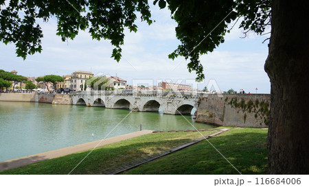 Historical roman Tiberius Bridge over Marecchia river in Rimini at Italy 116684006