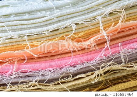 stack of colourful cotton clothes, close up pile of clothing 116685464