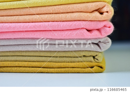 stack of colourful cotton clothes, close up pile of clothing 116685465