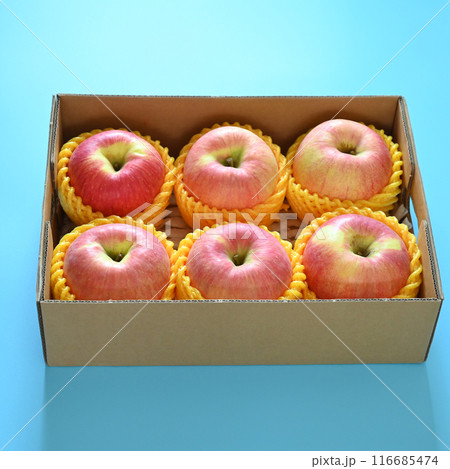 beautiful pink apple in the box on blue background 116685474