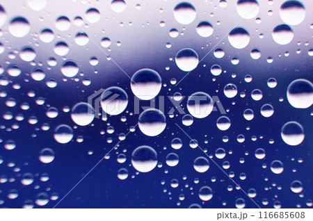 Straight view of water droplets on clear glass on blurred nature background. Suitable for design and wallpaper Straight view of water droplets on clear glass on blurred nature background. Suitable for design and wallpaper 116685608
