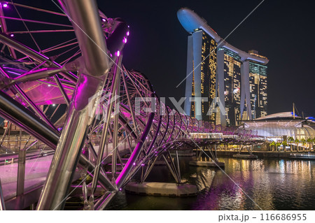 Helix bridge pink light up with Marina Bay Sands at night, Singapore 116686955