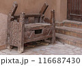 Rustic Wooden Bench with Intricate Carvings 116687430