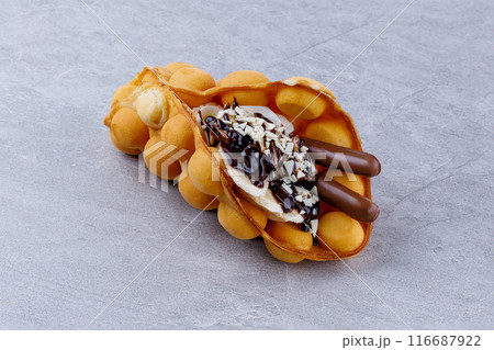 Delicious sweet bubble waffles on grey table 116687922