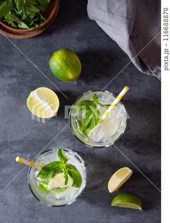 Concept flatlay mojito drink. Two glasses of lime lemonade with lime slices  116688870