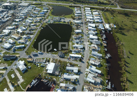 Destroyed by hurricane Ian suburban houses in Florida mobile home residential area. Consequences of natural disaster 116689406