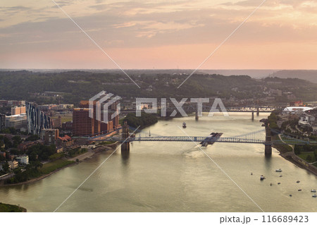 Covington Kentucky. Evening urban landscape of downtown district in USA. Skyline with bridge traffic and brightly illuminated high skyscraper buildings in modern American city 116689423