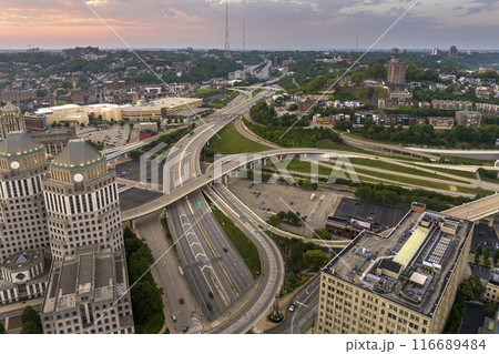 Cincinnati, Ohio transportation infrastructure. View from above of American big freeway intersection at sunset with fast moving cars Cincinnati, Ohio transportation infrastructure. View from above of American big freeway intersection at sunset with fast moving cars 116689484