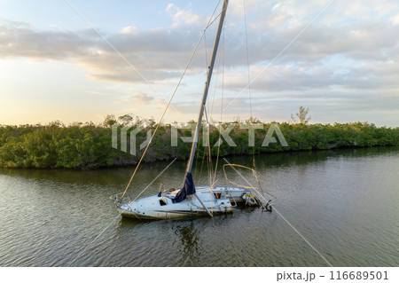 Capsized sunken sailing boat left forsaken on shallow bay waters after hurricane Ian in Manasota, Florida Capsized sunken sailing boat left forsaken on shallow bay waters after hurricane Ian in Manasota, Florida 116689501