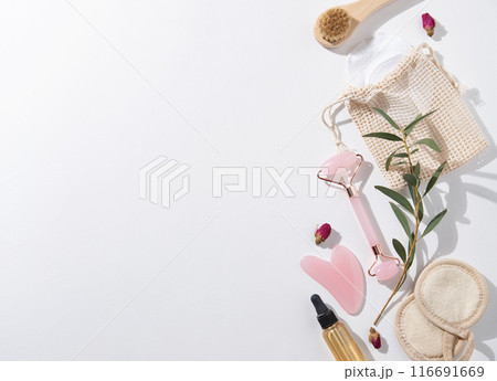 Flat lay beauty spa  with natural cosmetic products peeling natural soap, sponges, pink gua sha, oil 116691669