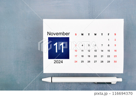 November Calendar 2024 page with pen on blue wooden. 116694370