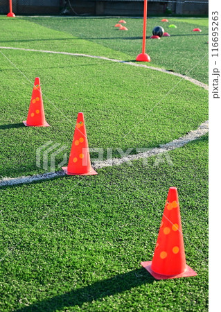 artificial green grass soccer field with orange training cones 116695263