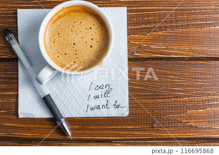 Hand written note on a coffee stained napkin with an empowe 116695868
