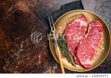 Alternative beef steak Denver, raw meat steak with herbs. Dark background. Top view. Copy space Alternative beef steak Denver, raw meat steak with herbs. Dark background. Top view. Copy space 116695971