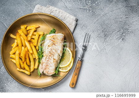 Fried cod fish fillet served with french fries. White background. Top view. Copy space 116695999
