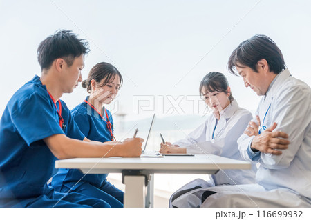真剣な表情でカンファレンスを開く男女の医療スタッフ 真剣な表情でカンファレンスを開く男女の医療スタッフ 116699932