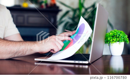 Investments in different sectors, analysis of markets in the office with diagrams and laptop 116700780