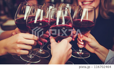 Friends with glasses of red wine celebrating a birthday or other important event. 116702464