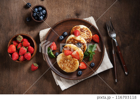Cottage cheese pancakes or syrniki with blueberries, strawberries and fresh mint Cottage cheese pancakes or syrniki with blueberries, strawberries and fresh mint 116703118