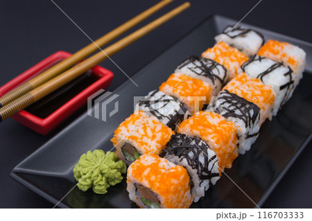 Sushi Composition with Soy Sauce and Wasabi on Dark Background 116703333
