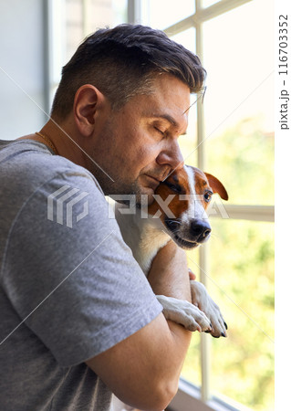 Adorable man and lovable pretty Jack Russel terrier Adorable man and lovable pretty Jack Russel terrier 116703352