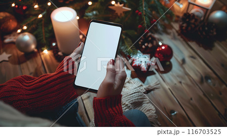 womans hands holding smartphone in rustic cafe blank white screen mockup wooden table background warm ambient lighting 116703525