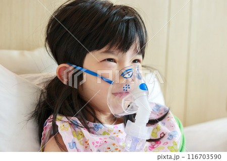 Sick little asian girl inhalation with nebulizer for respiratory treatment Sick little asian girl inhalation with nebulizer for respiratory treatment 116703590