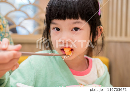 Cute little asian child girl eating food Cute little asian child girl eating food 116703671