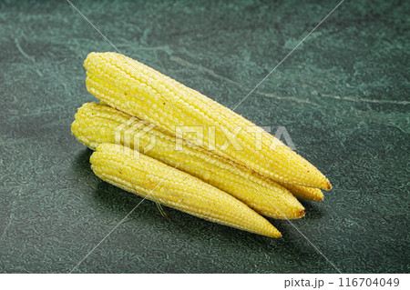 Raw sweet baby corn heap 116704049