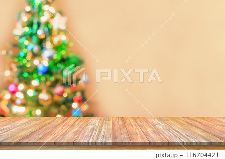 Empty wood table top with blur Christmas tree with bokeh light background 116704421