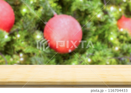 Empty wood table top with blur Christmas tree with bokeh light background 116704433