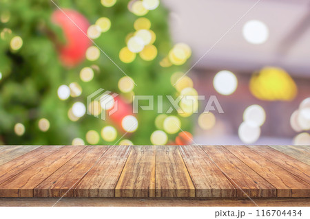 Empty wood table top with blur Christmas tree with bokeh light background 116704434