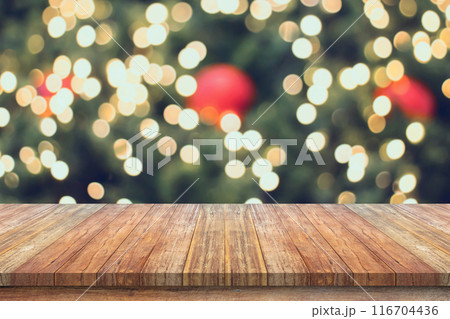Empty wood table top with blur Christmas tree with bokeh light background Empty wood table top with blur Christmas tree with bokeh light background 116704436