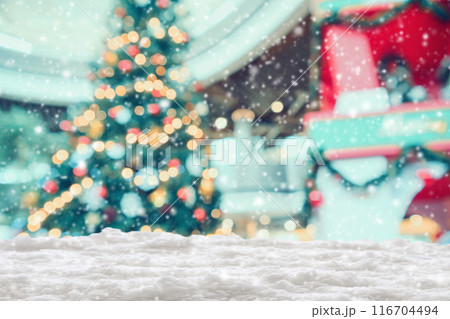Empty white snow with blur Christmas tree with bokeh light background 116704494