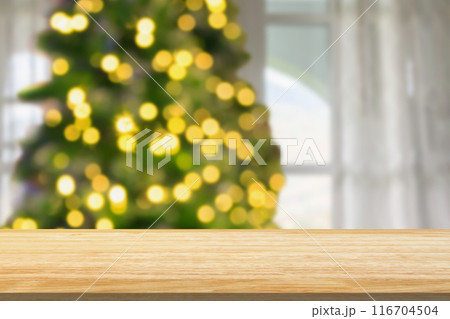 Empty table top with blurred Christmas tree with bokeh light background Empty table top with blurred Christmas tree with bokeh light background 116704504