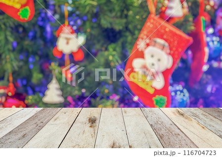 Empty wood table top with blur Christmas tree with bokeh light background Empty wood table top with blur Christmas tree with bokeh light background 116704723