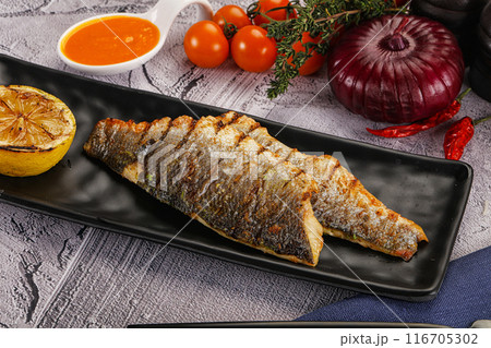 Grilled seabass fillet with lemon Grilled seabass fillet with lemon 116705302