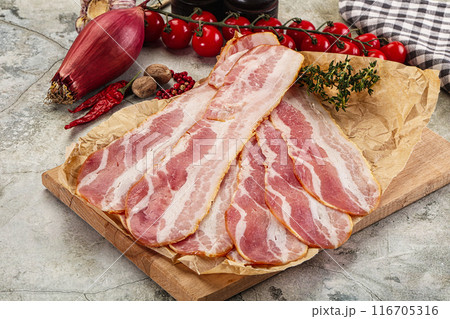 Sliced pork bacon over board 116705316