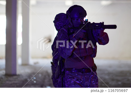 A group of professional soldiers bravely executes a dangerous rescue mission, surrounded by fire in a perilous building. 116705697