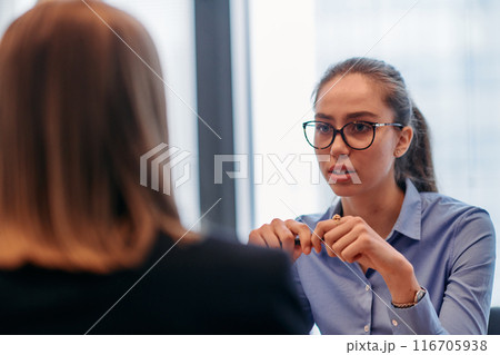 Businesswoman Leading Discussion in Modern Office Setting Businesswoman Leading Discussion in Modern Office Setting 116705938