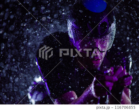 A triathlete braving the rain as he cycles through the night, preparing himself for the upcoming marathon 116706855
