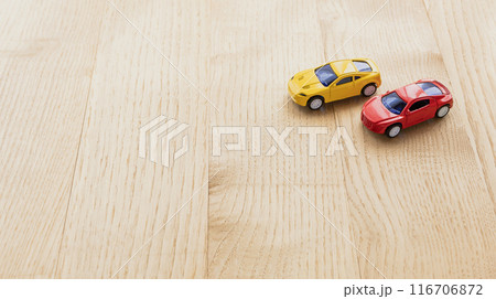 木製のテーブルの上に赤と黄色のミニカー 116706872
