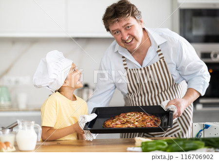 Father and daughter prepared pizza in kitchen Father and daughter prepared pizza in kitchen 116706902