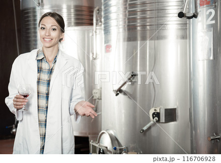 woman sommelier is tasting wine at wine factory woman sommelier is tasting wine at wine factory 116706928