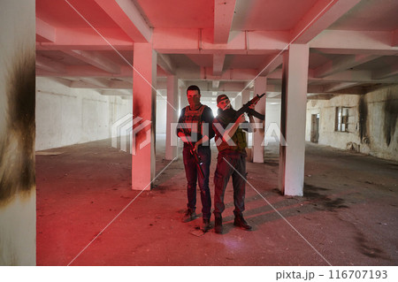 An abandoned building serves as the stronghold for a team of terrorists, fiercely guarding their occupied territory with guns and military equipment 116707193